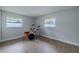 Spacious bedroom with hardwood floors and two windows, currently staged with a drum set at 1211 64Th Nw St, Bradenton, FL 34209