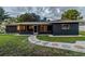 Home exterior featuring a pebble walkway and manicured lawn at 1211 64Th Nw St, Bradenton, FL 34209
