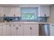 Well-lit kitchen featuring a large window above the sink, stainless steel appliances, and blue tile backsplash at 1211 64Th Nw St, Bradenton, FL 34209