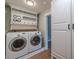 Bright laundry area with appliances, custom shelving, and additional storage at 1211 64Th Nw St, Bradenton, FL 34209