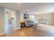 Bright living area with wood-look flooring, a couch, and an open layout to kitchen and dining areas at 1211 64Th Nw St, Bradenton, FL 34209