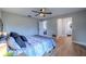 Bedroom featuring light gray walls, hardwood floors, ceiling fan, and access to an en-suite bathroom at 1211 64Th Nw St, Bradenton, FL 34209
