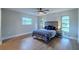 Bright bedroom with a ceiling fan, hardwood floors, and large windows offering natural light at 1211 64Th Nw St, Bradenton, FL 34209