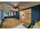 Enclosed patio with seating area, textured blue walls, and a sliding glass door to the kitchen at 1211 64Th Nw St, Bradenton, FL 34209