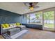 Enclosed patio featuring comfortable seating, textured walls, and views of the backyard at 1211 64Th Nw St, Bradenton, FL 34209