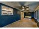 Enclosed patio with blue textured walls, comfortable seating, and backyard views at 1211 64Th Nw St, Bradenton, FL 34209
