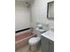 Updated bathroom featuring a white vanity with countertop and a pink tiled bathtub at 1257 Drew St # 15, Clearwater, FL 33755