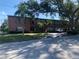 Apartment building showcasing brick and siding, balconies with dark railings, and mature trees at 1257 Drew St # 15, Clearwater, FL 33755