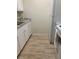 Updated kitchen featuring new wood-look flooring, white cabinets, and granite-style countertops at 1257 Drew St # 15, Clearwater, FL 33755