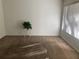 Cozy living room featuring neutral carpet, white walls, vertical blinds, and natural light at 1257 Drew St # 15, Clearwater, FL 33755