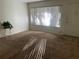 Living room featuring neutral carpet, white walls, bright window with blinds and access to the outside at 1257 Drew St # 15, Clearwater, FL 33755