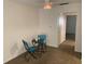 Carpeted living room with a small table and chairs next to the doorway leading to the kitchen at 1257 Drew St # 15, Clearwater, FL 33755