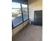 Enclosed porch area with tiled floor and a large window overlooking the parking lot at 1257 Drew St # 15, Clearwater, FL 33755