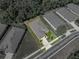 Drone's-eye view displays the home's full lot, neat landscaping and a surrounding of matched, similar houses at 12669 Eastpointe Dr, Dade City, FL 33525