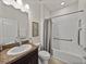 Well-lit bathroom with a large vanity, granite countertops, and a shower-tub combo for convenience at 12669 Eastpointe Dr, Dade City, FL 33525