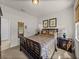 Stylish bedroom featuring sophisticated decor, including dark wood furniture, providing a tranquil escape at 12669 Eastpointe Dr, Dade City, FL 33525