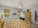 Inviting bedroom boasts a decorative armoire and chest with natural light streaming through the windows at 12669 Eastpointe Dr, Dade City, FL 33525