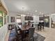 Open dining room and kitchen with modern stainless steel appliances, granite countertops, and elegant fixtures at 12669 Eastpointe Dr, Dade City, FL 33525