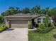 Charming single-story home featuring a well-maintained lawn, a two car garage and neatly trimmed landscaping at 12669 Eastpointe Dr, Dade City, FL 33525