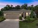 Charming single-story home featuring a well-maintained lawn, a two car garage and neatly trimmed landscaping at 12669 Eastpointe Dr, Dade City, FL 33525