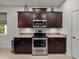 Well-equipped kitchen featuring stainless steel oven, cooktop, and ample cabinet space with granite countertops at 12669 Eastpointe Dr, Dade City, FL 33525