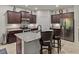 Modern kitchen with granite countertops, stainless steel appliances, and breakfast bar seating at 12669 Eastpointe Dr, Dade City, FL 33525