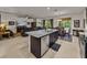 Open floor plan kitchen with granite island, stainless appliances, and living area in background at 12669 Eastpointe Dr, Dade City, FL 33525