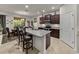 Open kitchen with granite counters, breakfast bar, and modern appliances, seamlessly connected to dining area at 12669 Eastpointe Dr, Dade City, FL 33525