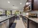 Kitchen with stainless steel appliances, granite countertops, and seamless flow into dining area at 12669 Eastpointe Dr, Dade City, FL 33525