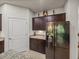 Kitchen featuring granite countertops, stainless steel refrigerator, and ample cabinet storage space at 12669 Eastpointe Dr, Dade City, FL 33525