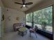 Relaxing screened-in lanai featuring wicker furniture, perfect for enjoying nature while staying bug-free at 12669 Eastpointe Dr, Dade City, FL 33525