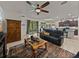 Bright living room with sliding glass doors, comfortable seating, and connection to the kitchen at 12669 Eastpointe Dr, Dade City, FL 33525