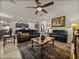 Open-concept living room features cozy seating, stylish rug, and seamless transition to the kitchen at 12669 Eastpointe Dr, Dade City, FL 33525