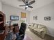 Functional home office featuring a desk, couch, and ceiling fan, creating a productive environment at 12669 Eastpointe Dr, Dade City, FL 33525