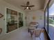 A screened-in patio features a ceiling fan, sun decor, and wicker furniture for relaxing and enjoying the outdoors at 12669 Eastpointe Dr, Dade City, FL 33525