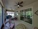 The screened-in patio offers ample space for dining and relaxation with outdoor furniture and a ceiling fan at 12669 Eastpointe Dr, Dade City, FL 33525