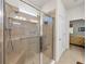 Modern bathroom featuring a spacious walk-in shower with glass doors and a convenient shower seat at 12669 Eastpointe Dr, Dade City, FL 33525
