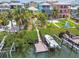 Aerial view of waterfront property with boat dock, manicured yard, and vibrant neighborhood at 1326 Apollo Beach S Blvd, Apollo Beach, FL 33572
