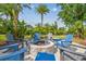 Backyard fire pit area with Adirondack chairs, lush landscaping and a paver path at 1326 Apollo Beach S Blvd, Apollo Beach, FL 33572