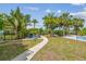 Relaxing backyard featuring a lush tropical paradise with a paver path and a sitting area at 1326 Apollo Beach S Blvd, Apollo Beach, FL 33572
