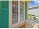 Charming balcony features french doors, a bistro set, and colorful accents at 1326 Apollo Beach S Blvd, Apollo Beach, FL 33572