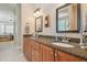Spacious bathroom with double sinks and granite countertops and wooden cabinets at 1326 Apollo Beach S Blvd, Apollo Beach, FL 33572