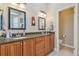 Bathroom with dual vanities, granite countertops, and a separate toilet room at 1326 Apollo Beach S Blvd, Apollo Beach, FL 33572
