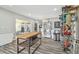 Spacious bonus room with wood-look flooring, wet bar, refrigerator, and stainless steel shelving at 1326 Apollo Beach S Blvd, Apollo Beach, FL 33572