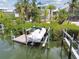 This boat sits on a private boat lift at a dock, providing a convenient waterfront lifestyle at 1326 Apollo Beach S Blvd, Apollo Beach, FL 33572