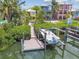 Private boat dock and lift provide easy access to waterfront living, set amid lush greenery at 1326 Apollo Beach S Blvd, Apollo Beach, FL 33572