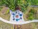 Aerial view of a charming outdoor fire pit area surrounded by comfortable seating and lush landscaping at 1326 Apollo Beach S Blvd, Apollo Beach, FL 33572