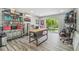 Versatile flex room with potential home brewery featuring an work table, shelving and backyard views at 1326 Apollo Beach S Blvd, Apollo Beach, FL 33572