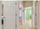 Hallway with hardwood floors leading to colorful bedrooms and laundry room at 1326 Apollo Beach S Blvd, Apollo Beach, FL 33572
