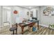 Bright hobby room featuring a large craft table, storage solutions, and wood-look flooring at 1326 Apollo Beach S Blvd, Apollo Beach, FL 33572
